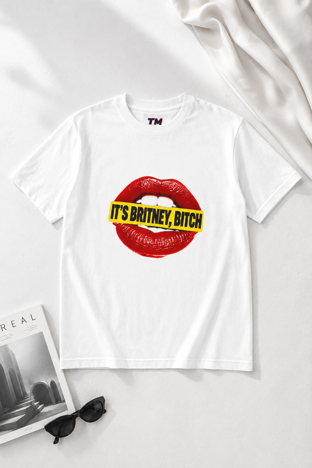 White It’s Britney, Bitch Britney Spears homage graphic T-shirt in an editorial flat lay.