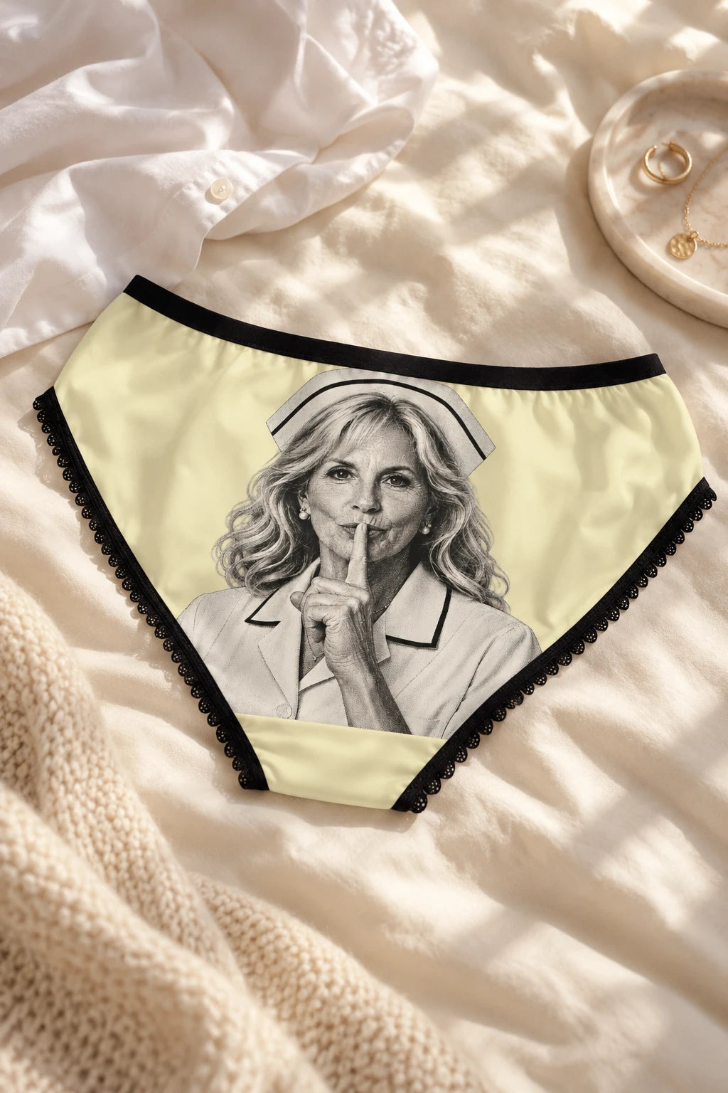 Jill Biden political satire panty back view styled on cream bedding with black lace trim