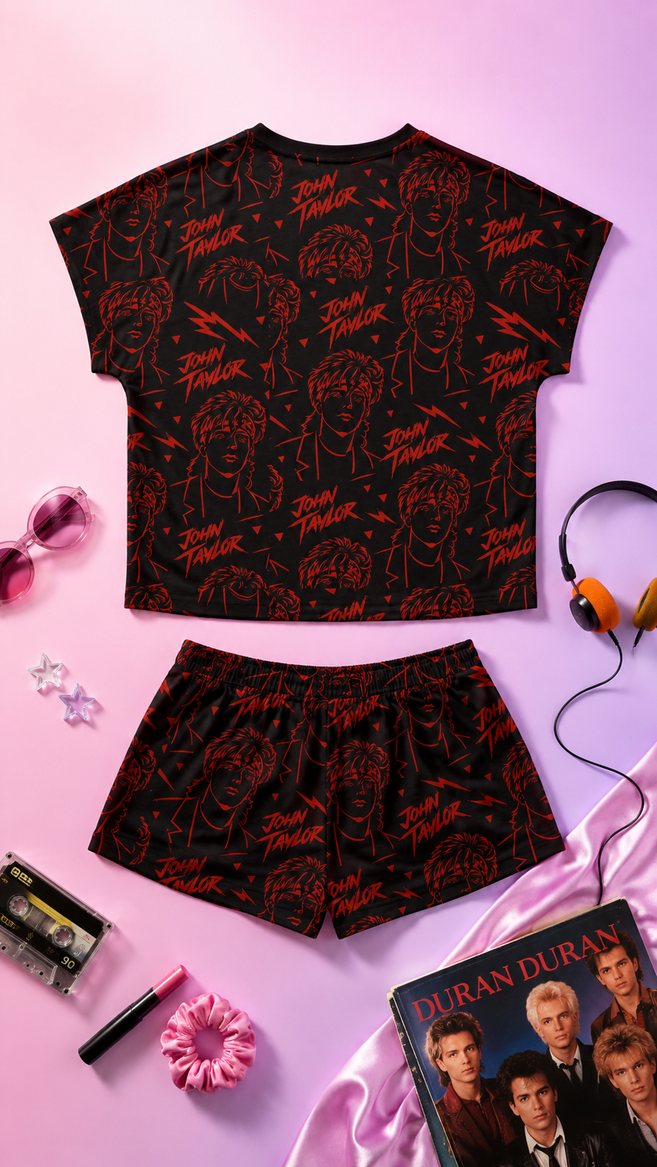 Editorial flat lay back view mockup of John Taylor women’s pajama set with retro 80s music inspired all-over print and Duran Duran aesthetic accessories on pink gradient background
