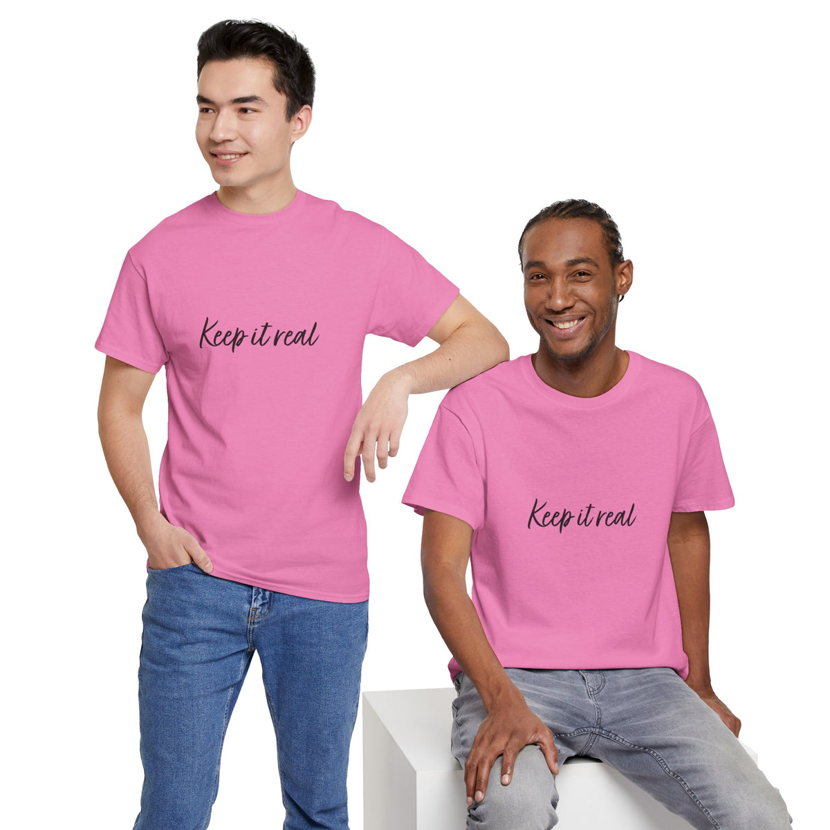Two men modeling Tantrum Media’s pink Keep It Real T-Shirt with black script lettering, styled with jeans.