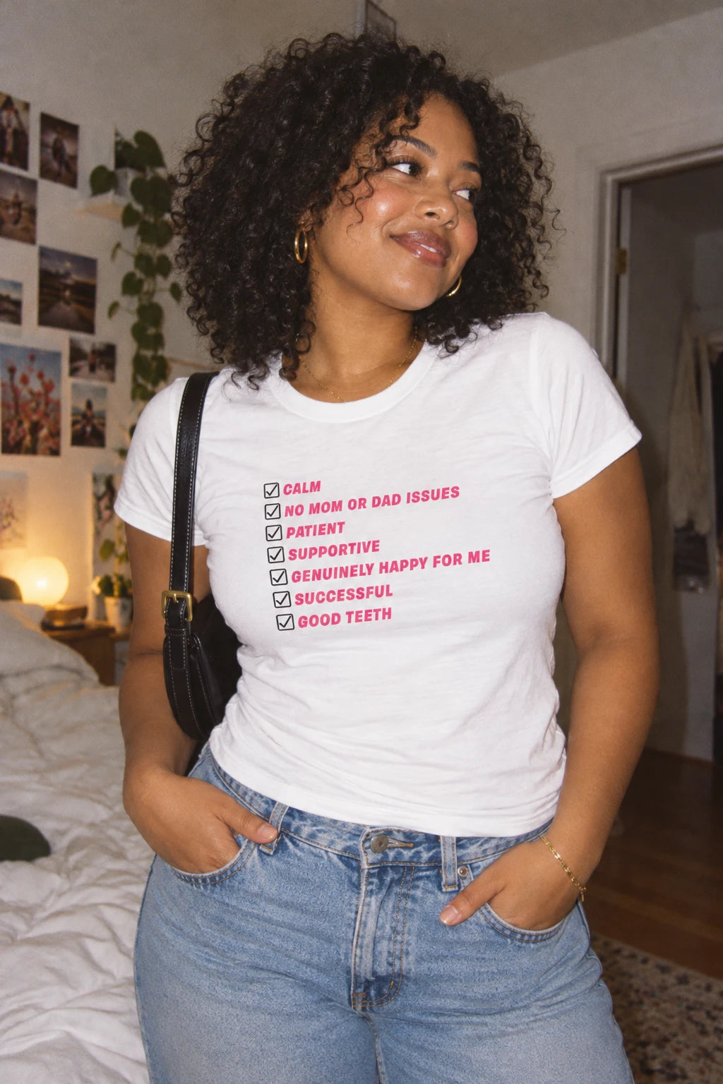 Woman wearing white Kim Kardashian Boyfriend Must Have List women’s T-shirt with pink checklist design