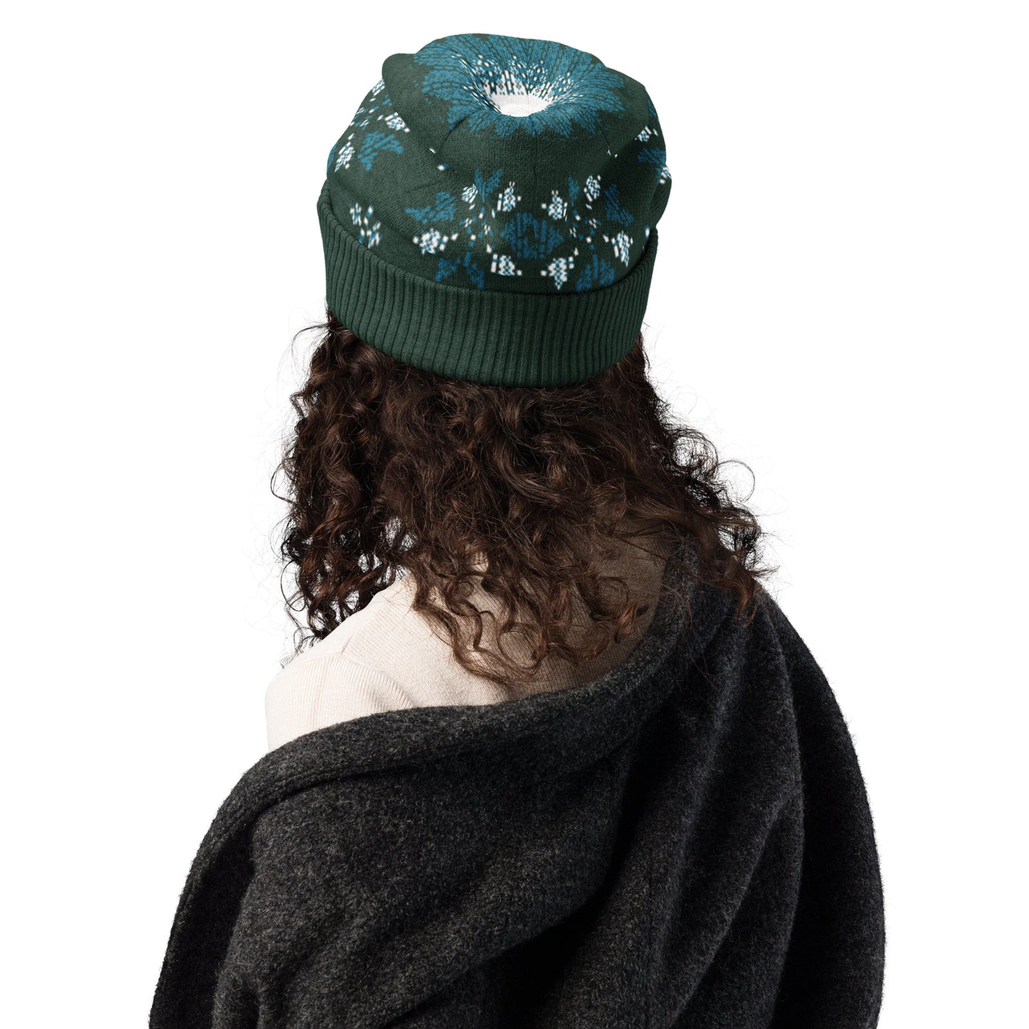 Rear view of a person wearing the dark green patterned beanie and a dark sweater.