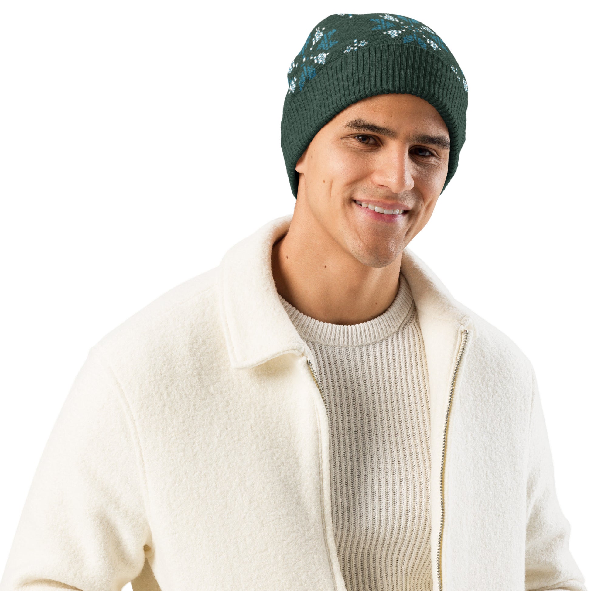Studio view of a person wearing the dark green patterned beanie with a light jacket, smiling.