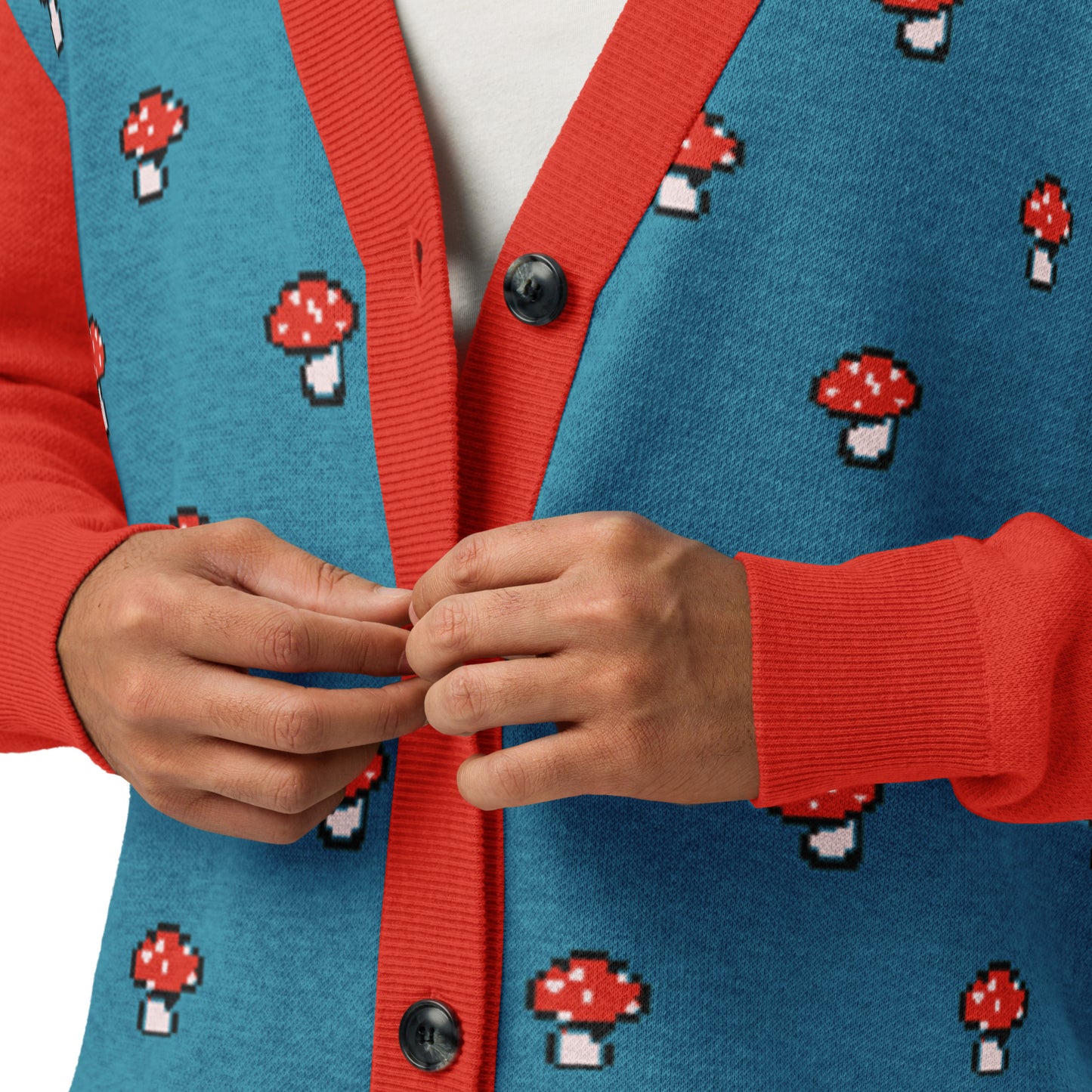Close up of the blue and red pixel mushroom cardigan showing knit texture and button details.