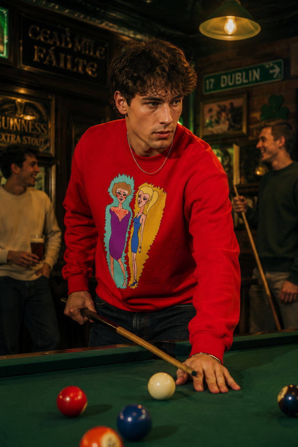 Male wearing red Lads Unisex Graphic Sweatshirt while playing pool in a cinematic pub setting.
