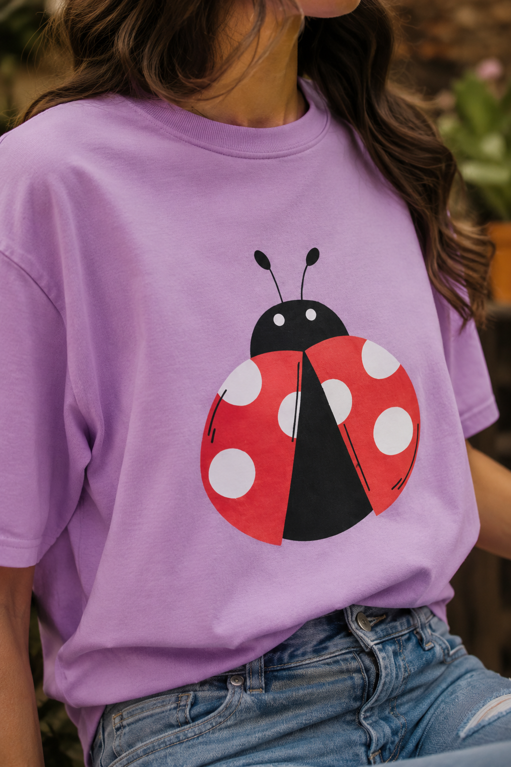 Close-up of lavender Ladybug Graphic Unisex T-Shirt showing print detail