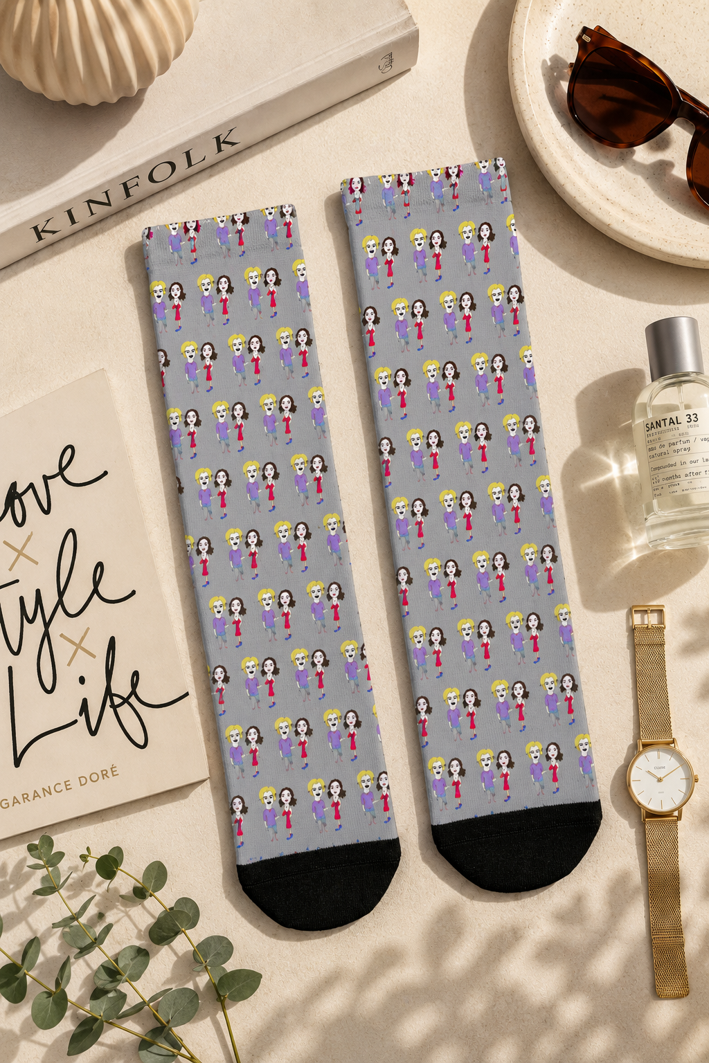 Editorial flat-lay of Lily & Matthew Patterned Crew Socks from the Sketchbook Collection displayed on a soft cream background with lifestyle accessories, showcasing the original illustrated artwork in a cinematic product photography composition.