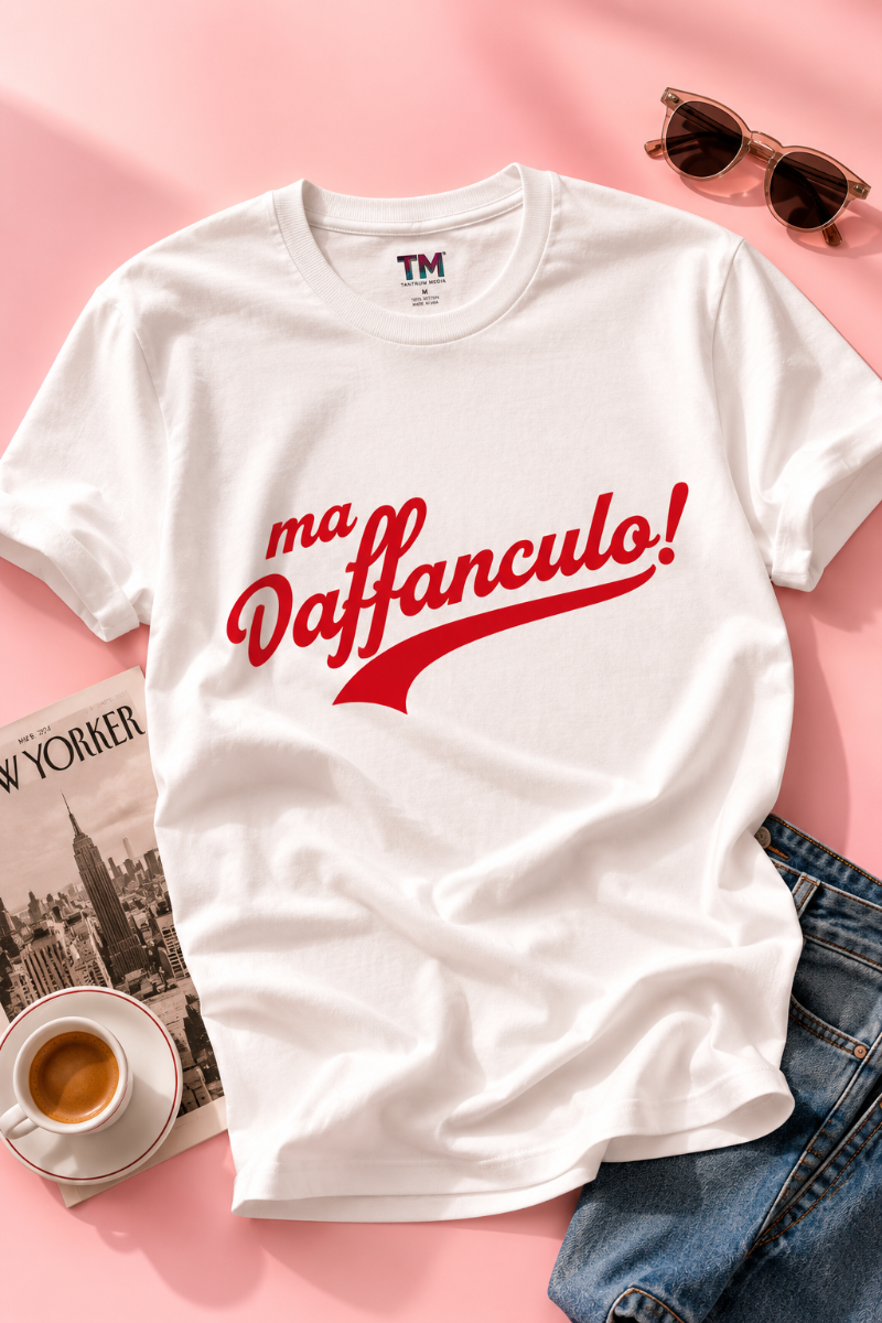 Folded Ma Vaffanculo graphic t-shirt on a pastel pink background.