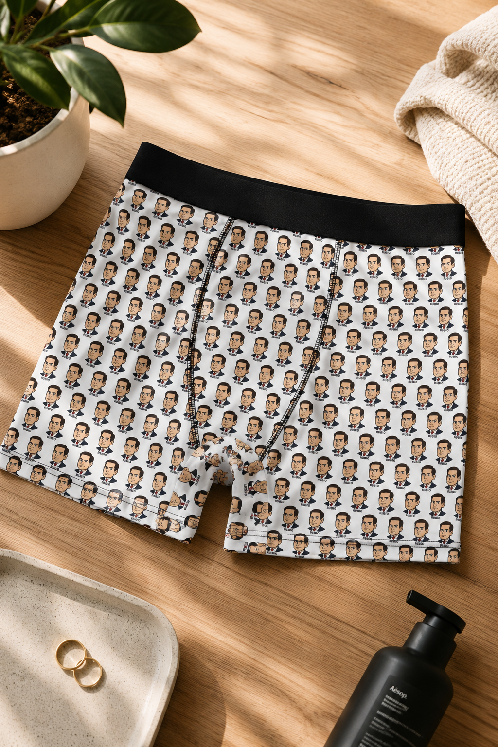 Editorial flat lay mockup of Marco Rubio patterned boxer briefs on a warm wooden background with luxury grooming accessories and soft natural sunlight.