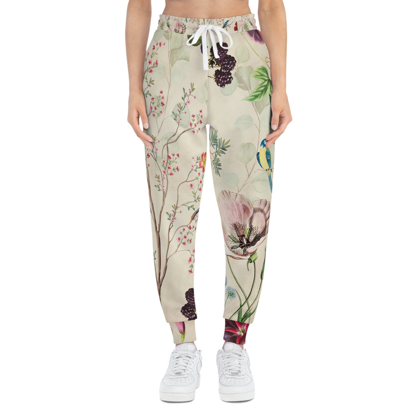 Floral and botanical patterned pants worn by a person on a white background