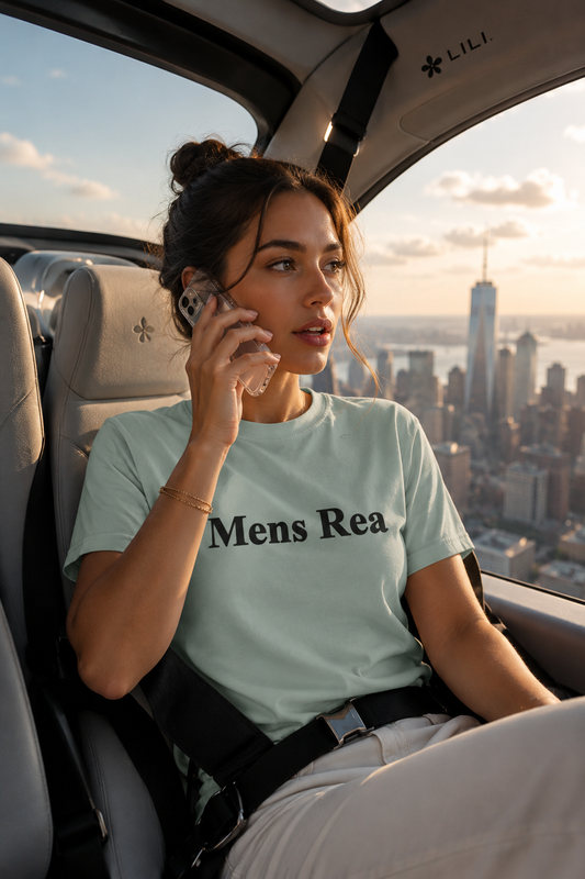 Young millennial woman wearing a mint green Mens Rea graphic T-shirt while speaking on a transparent cellphone inside a futuristic air taxi flying over the Manhattan skyline during golden hour in a cinematic editorial fashion mockup.