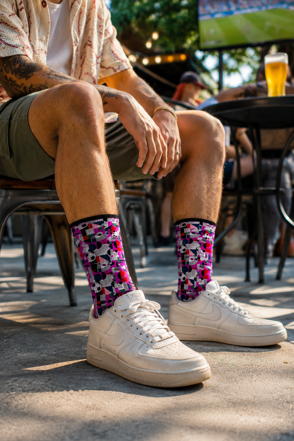 Casual outdoor lifestyle photo featuring FIFA World Cup 2026 soccer fan crew socks worn with sneakers.