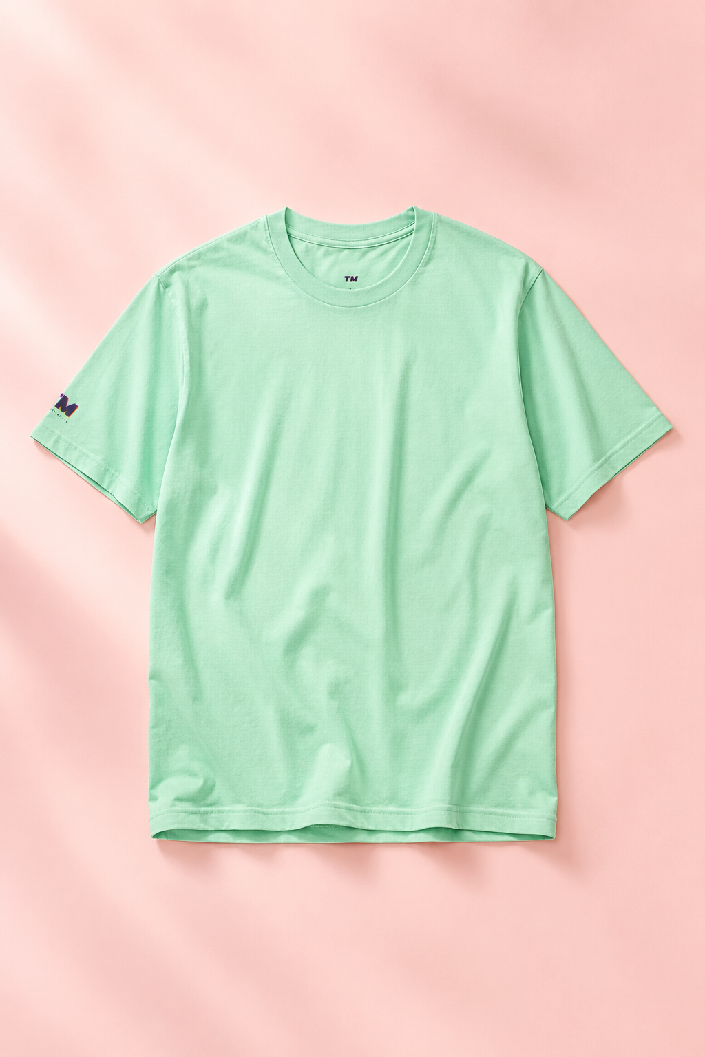 Editorial flat lay of a mint green cotton T-shirt.