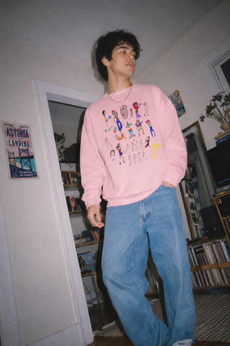 Gen Z man wearing pink Mix Art Crewneck Sweatshirt in Astoria Queens apartment