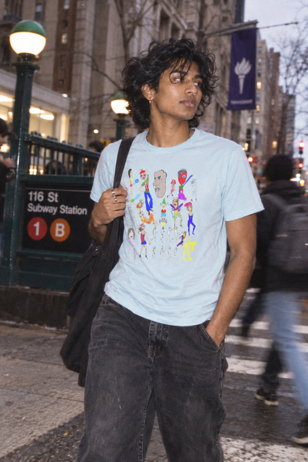 Man wearing the blue mist Mix hand-drawn graphic T-shirt in an urban city setting