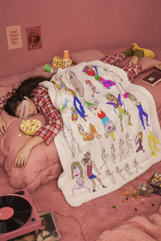 Mix colorful character art sherpa fleece blanket styled on a pink bed in a cozy retro bedroom