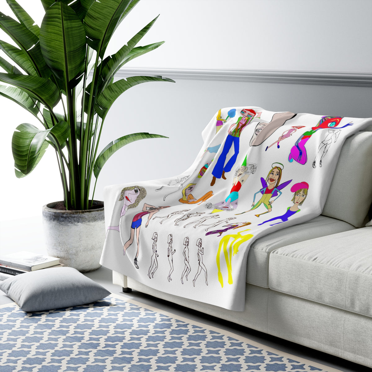 Mix colorful art sherpa fleece blanket styled on a modern sofa beside a large indoor plant