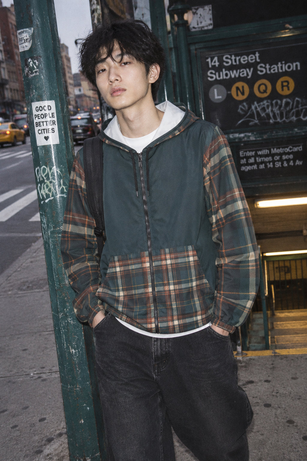 Gen Z man wearing Moss Plaid unisex windbreaker jacket in an urban streetwear setting