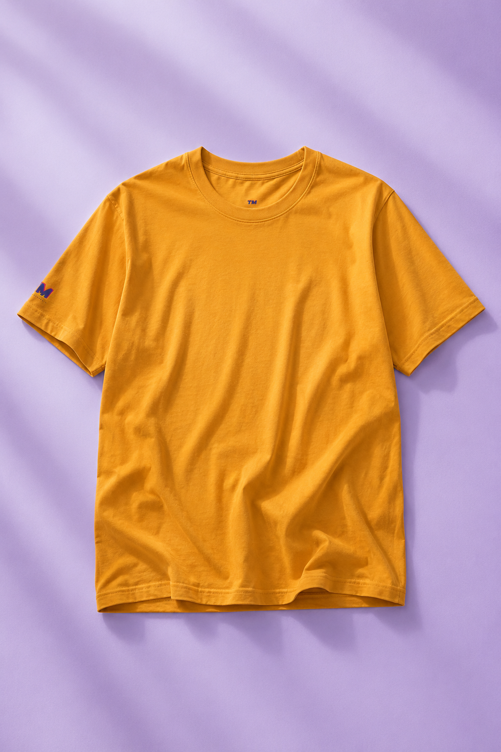 Editorial flat lay of a mustard yellow cotton T-shirt.