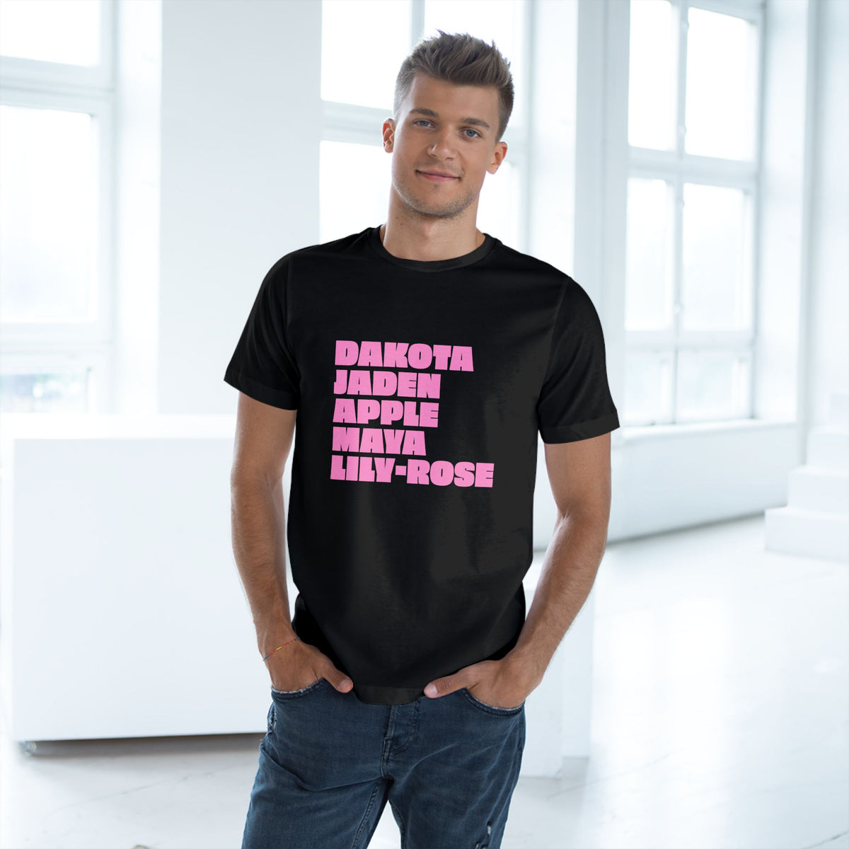 Man wearing black Nepo Babies List graphic T-shirt with pink print