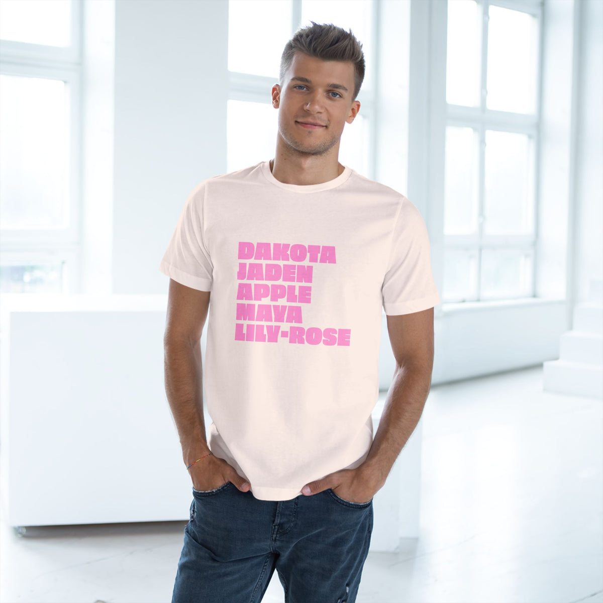 Man wearing soft pink Nepo Babies List graphic T-shirt
