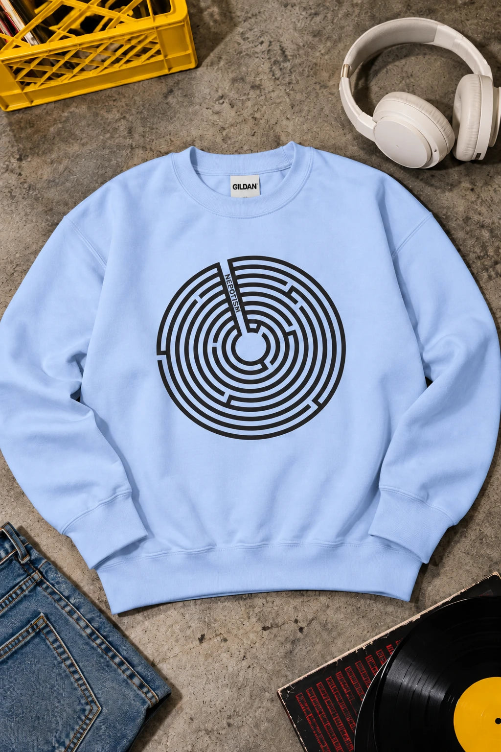 Baby blue Nepo sweatshirt with black anti-nepotism maze graphic in editorial flat lay.