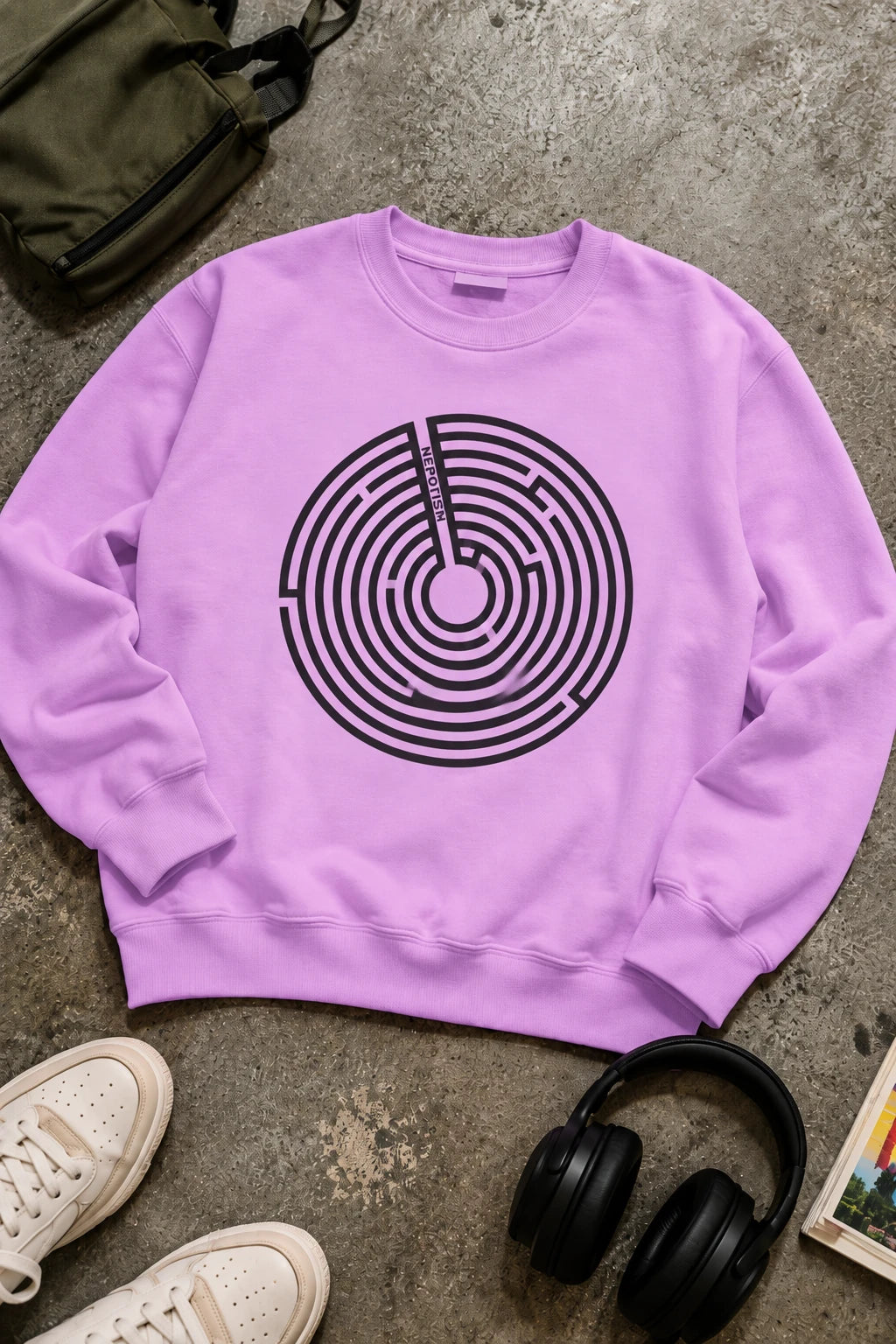 Lavender Nepo sweatshirt with black anti-nepotism maze graphic in streetwear flat lay.