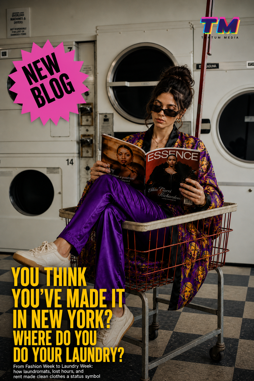 Millennial woman in laundromat sitting in laundry cart reading magazine, wearing Joan Forever Pop Art Kimono Robe with purple satin pants, New York fashion editorial about laundry and status