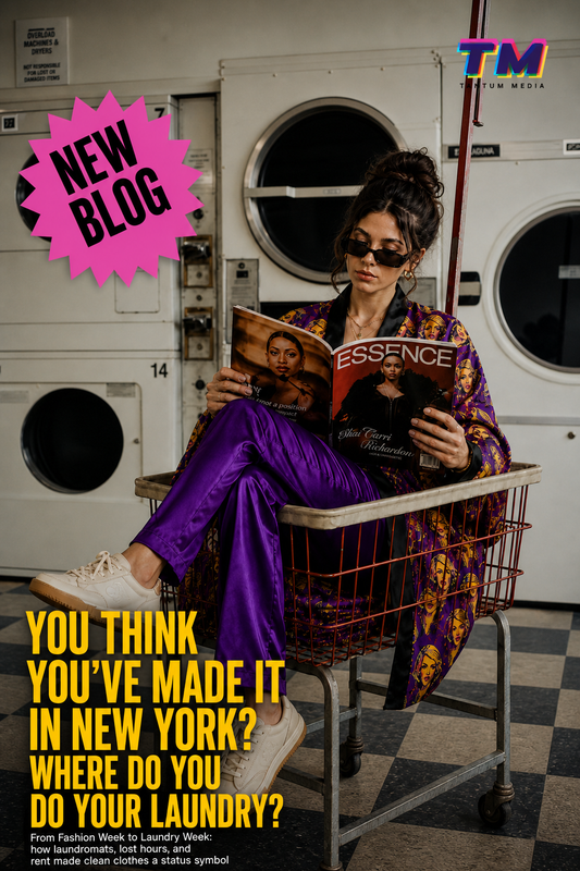 Millennial woman in laundromat sitting in laundry cart reading magazine, wearing Joan Forever Pop Art Kimono Robe with purple satin pants, New York fashion editorial about laundry and status