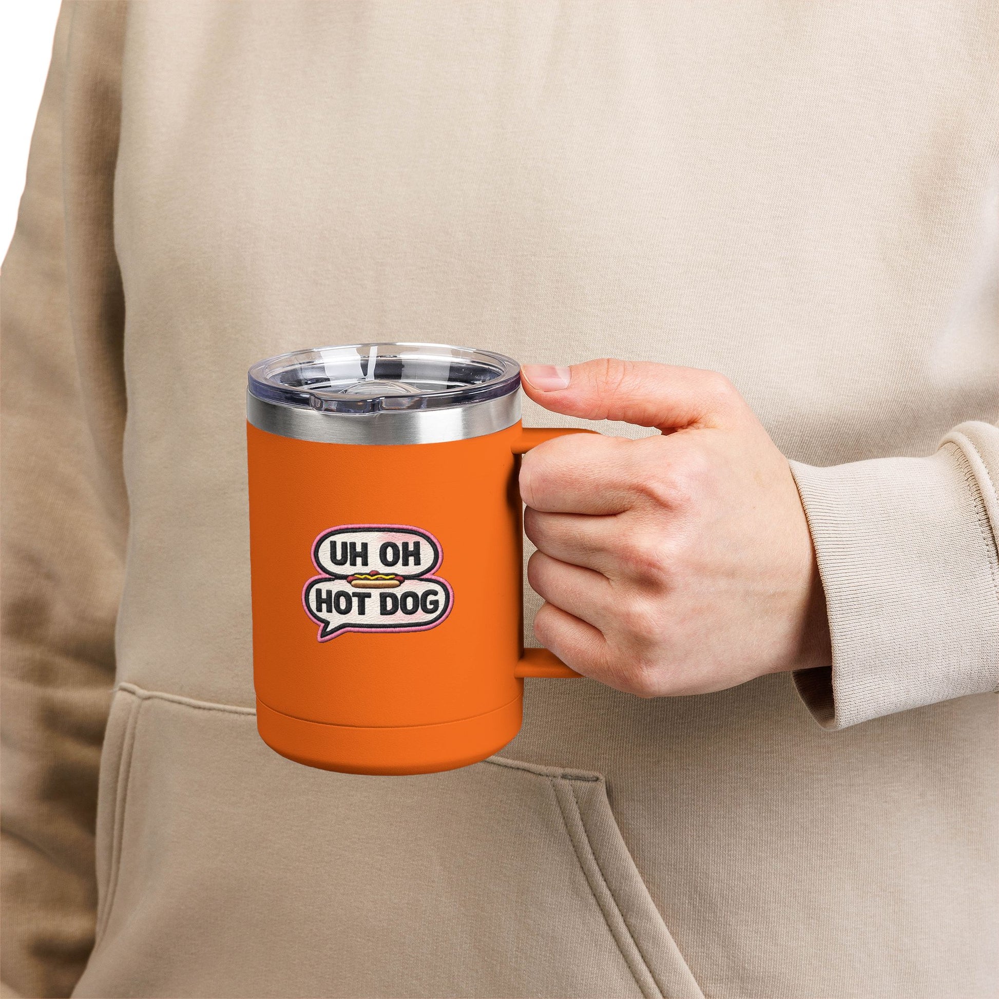 Person holding an orange Uh Oh Hot Dog MADtv insulated stainless steel travel mug