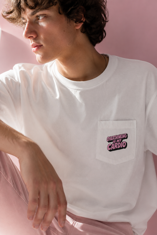 Close-up editorial portrait of model wearing Overthinking Is My Cardio pocket graphic T-shirt front view