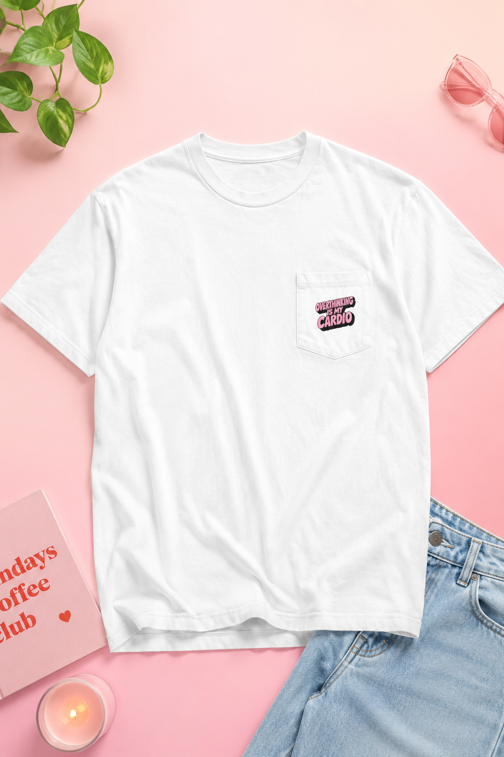 Flat lay of Overthinking Is My Cardio pocket T-shirt front on soft pastel pink background