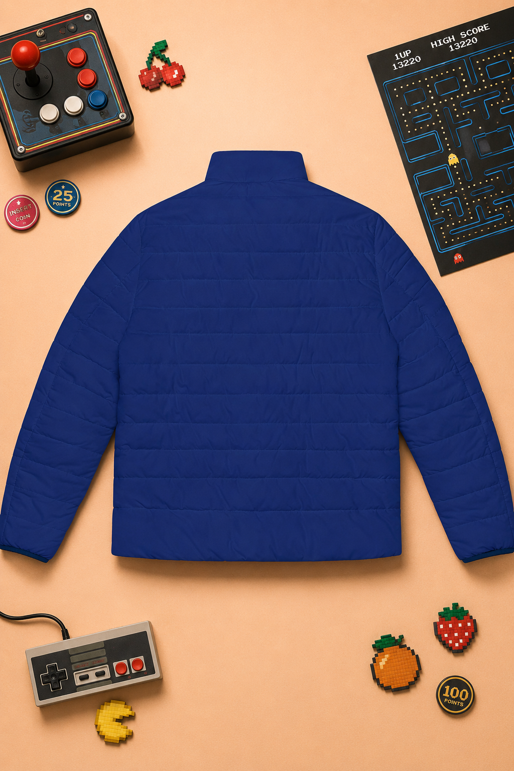 Rear flat lay of the Pac-Man Blinky Ghost blue puffer jacket on a peach background with retro arcade details.