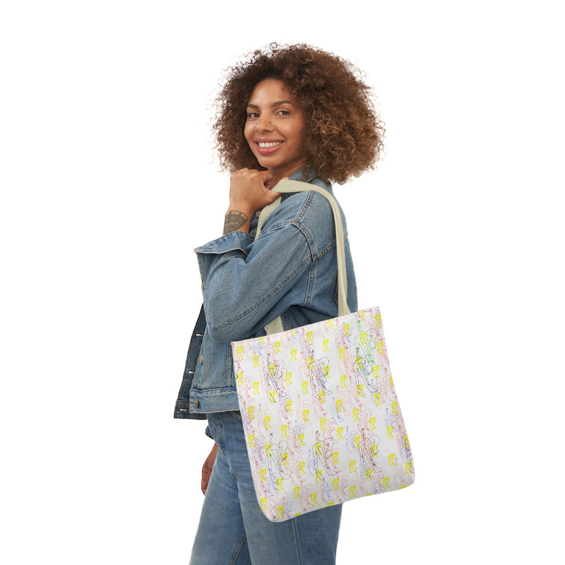 Woman carrying a white tote bag featuring a colorful repeating pattern of abstract line art figures in pastel shades