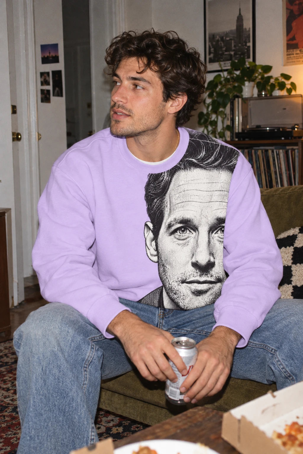Millennial man wearing Paul Rudd portrait sweatshirt in a casual apartment setting