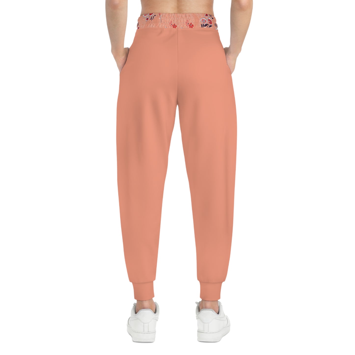 Close up of floral knee patch detail on peach floral joggers