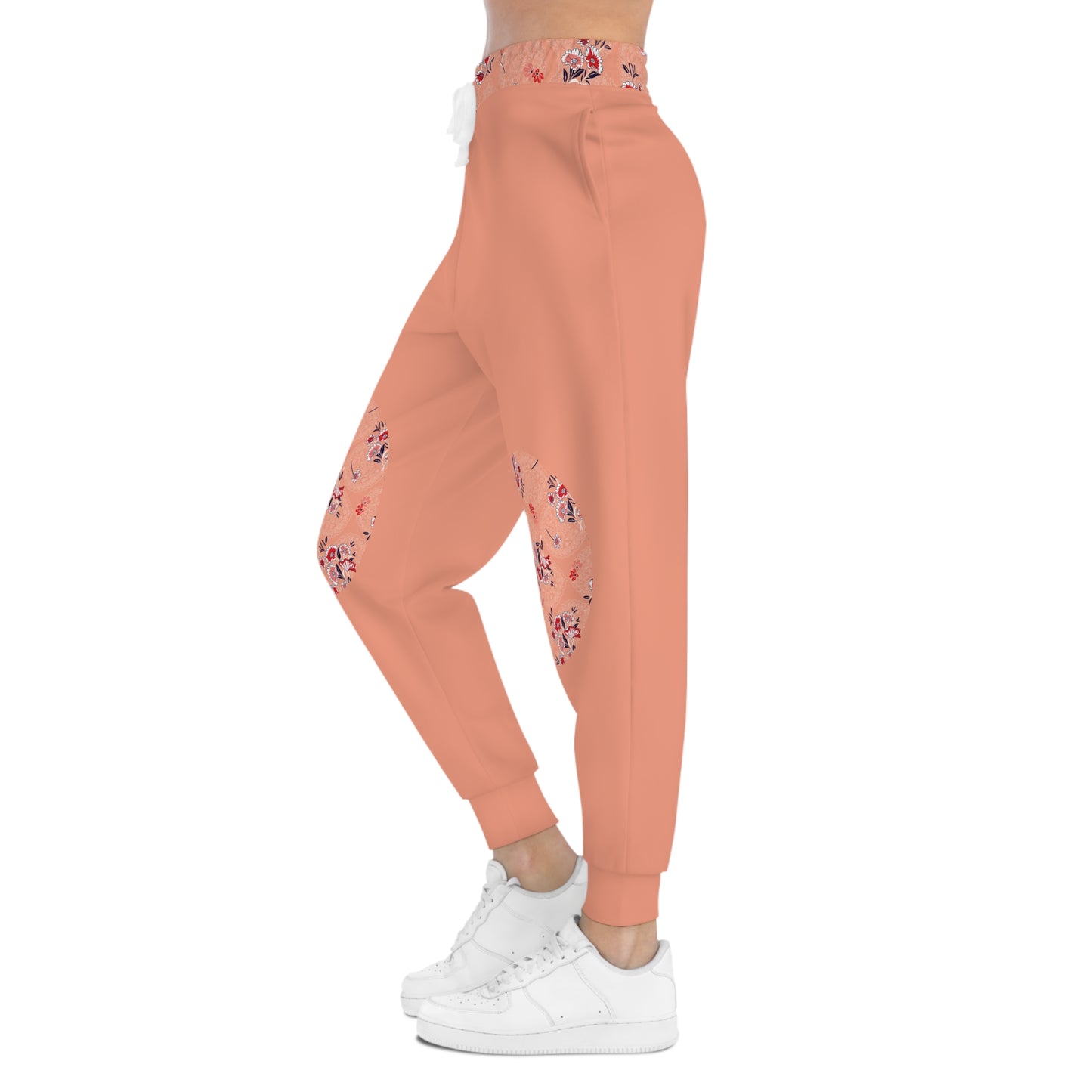 Side profile of peach floral joggers with floral knee patch detail