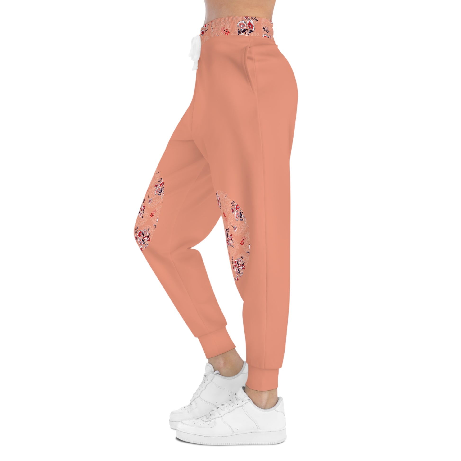 Side profile of peach floral joggers with floral knee patch detail