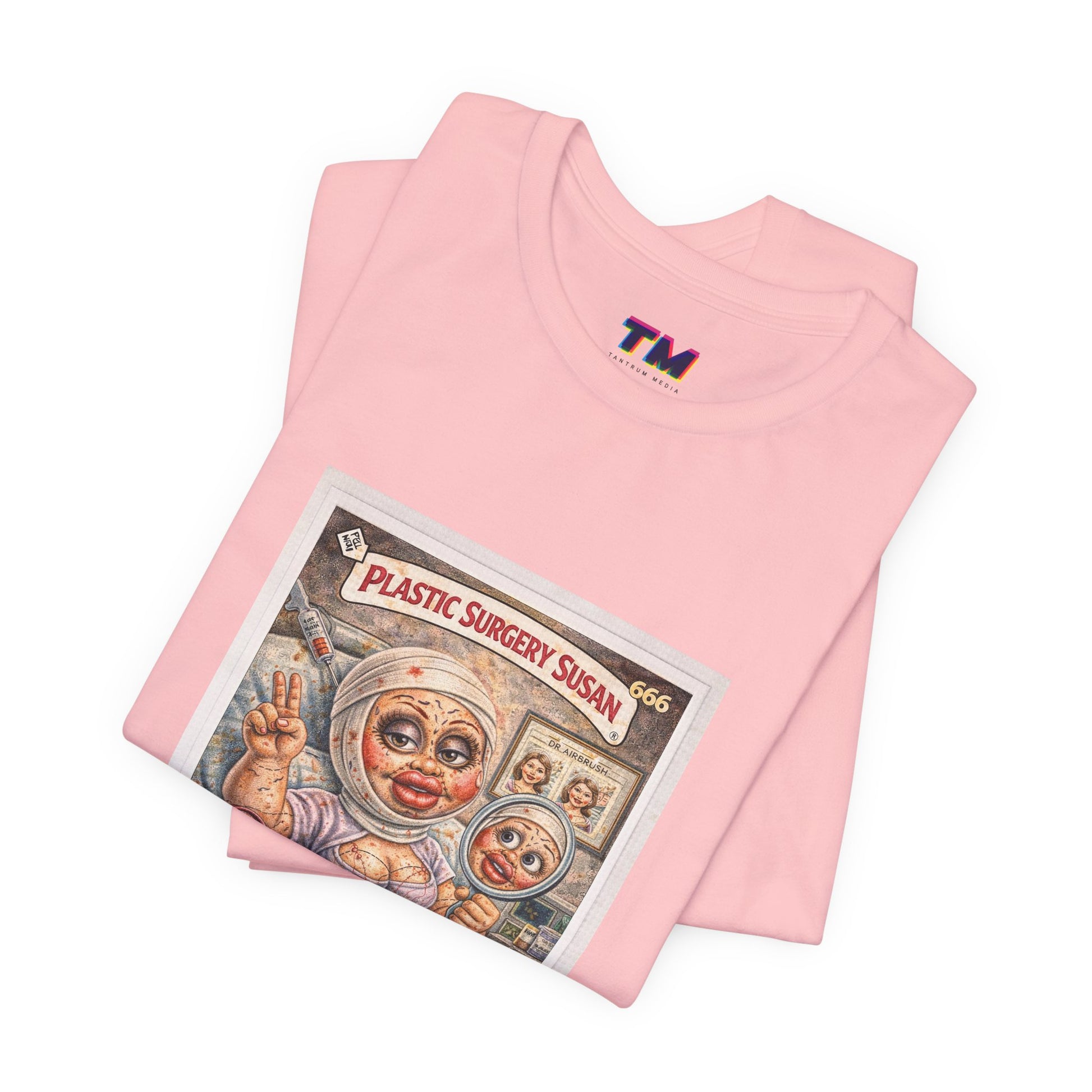 Folded pink Plastic Surgery Susan graphic t-shirt close up of vintage parody card print detail
