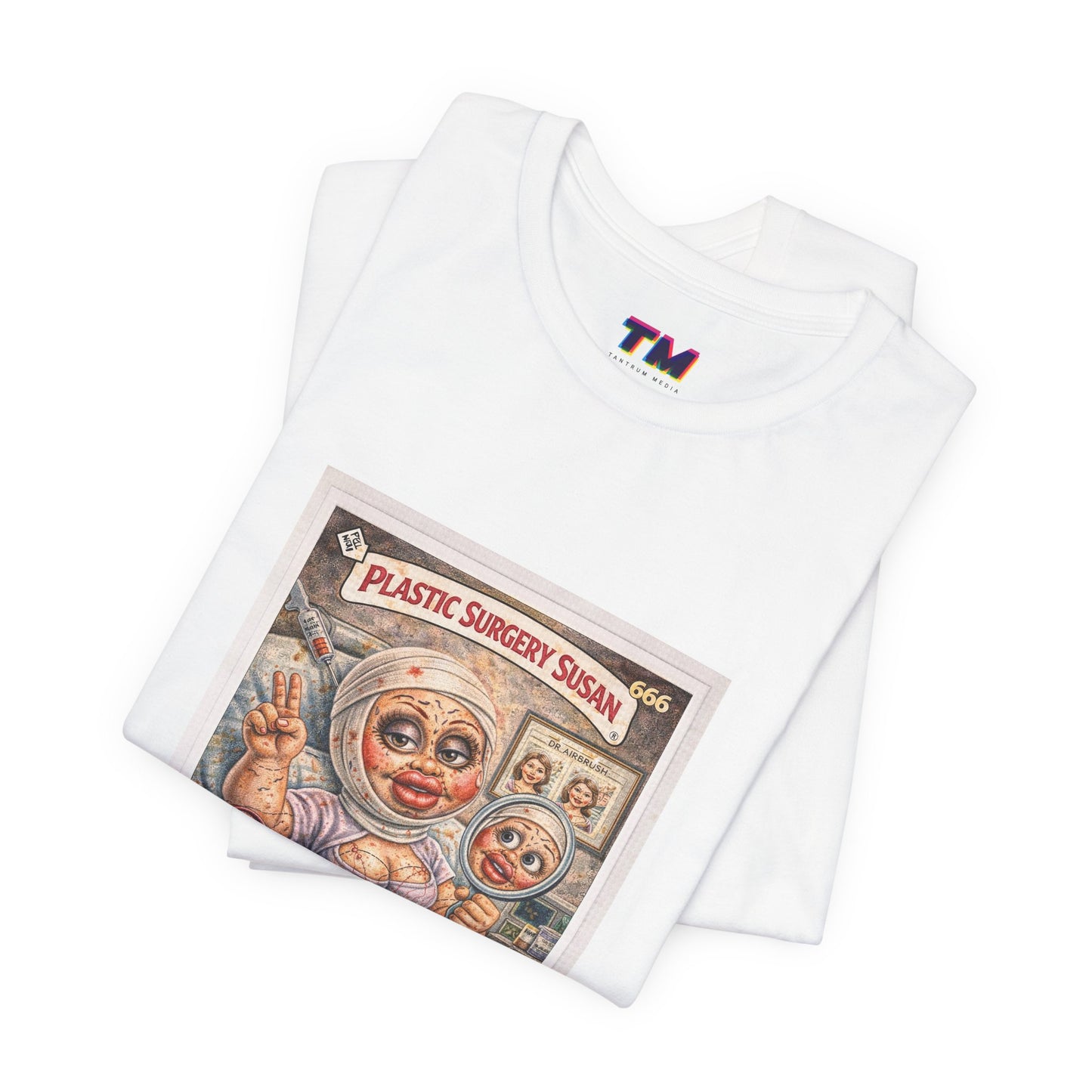 Stack of folded white Plastic Surgery Susan graphic t-shirts showing print detail and fabric texture