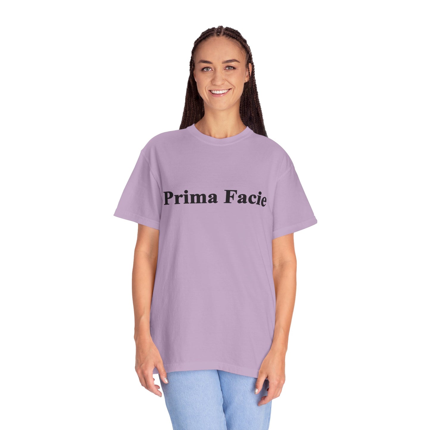 Young female model wearing a lavender Prima Facie unisex graphic T-shirt against a bright studio background.
