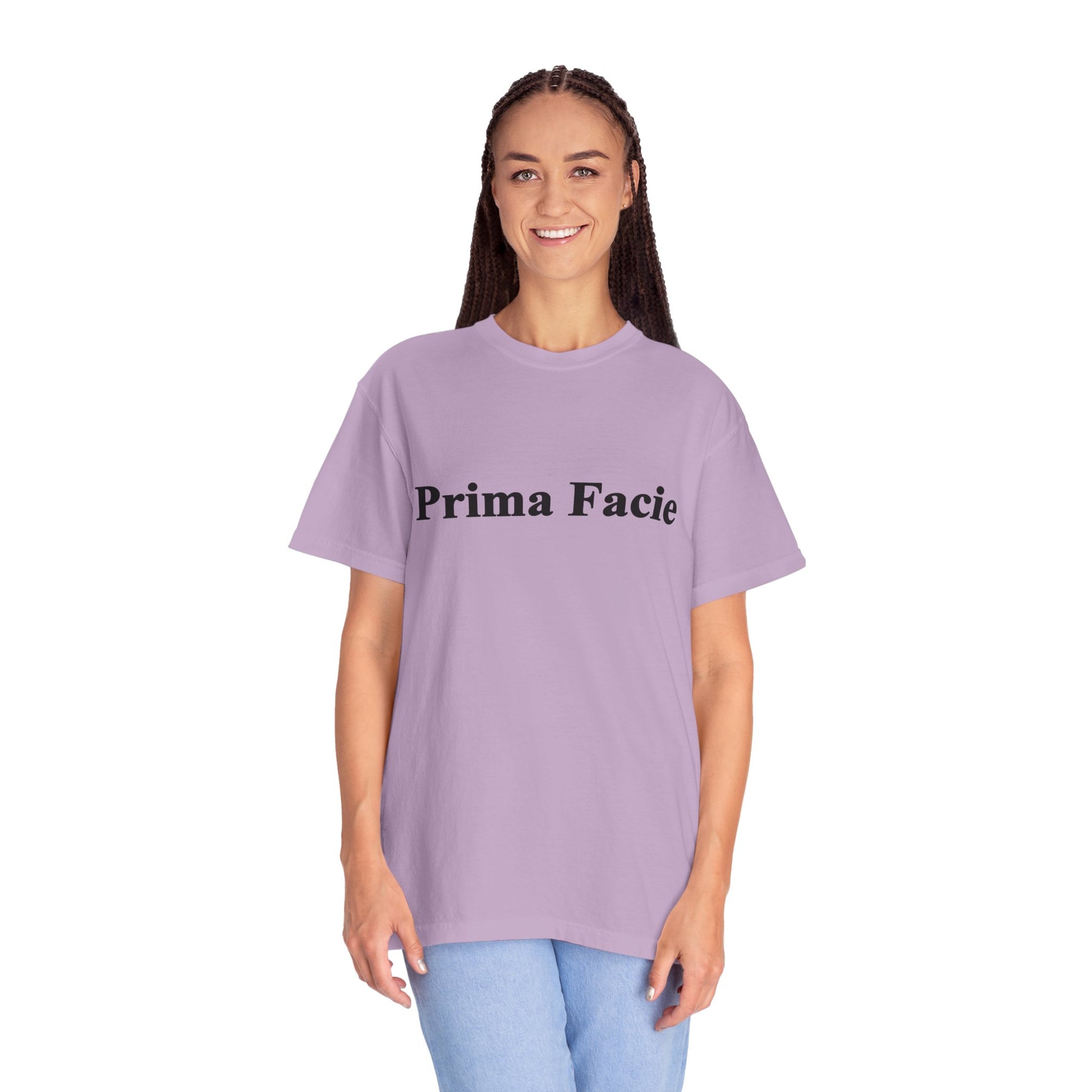 Young female model wearing a lavender Prima Facie unisex graphic T-shirt against a bright studio background.