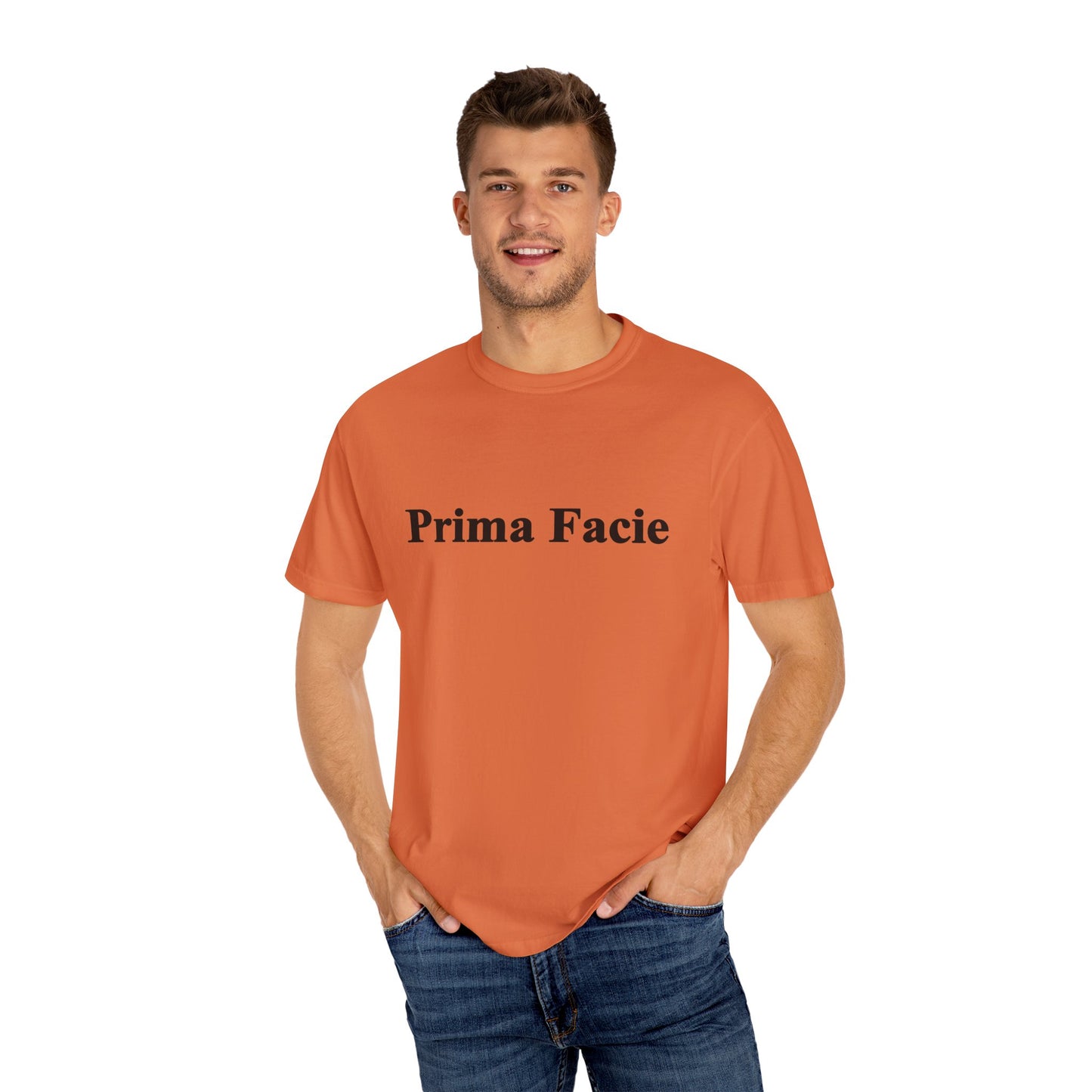 Young male model wearing an orange Prima Facie unisex graphic T-shirt styled casually against a clean background.