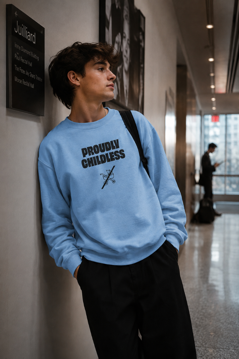 Gen Z man wearing the light blue Proudly Childless Sweatshirt in a Juilliard-style school hallway in New York City.