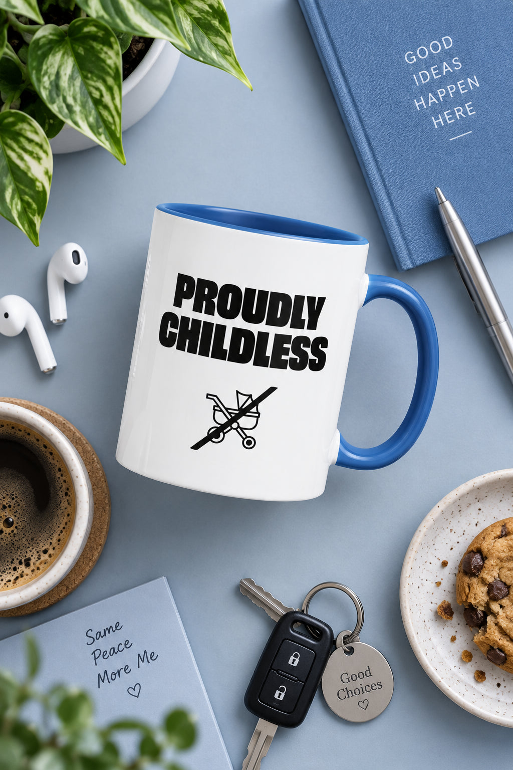 Blue Proudly Childless Mug in a styled flat lay with notebook, coffee and desk accessories