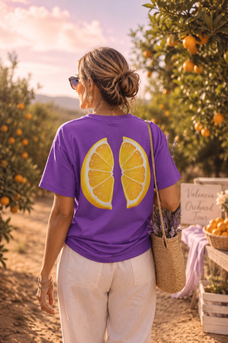 Close-up of purple lemon graphic T-shirt showing the large citrus wedge back print