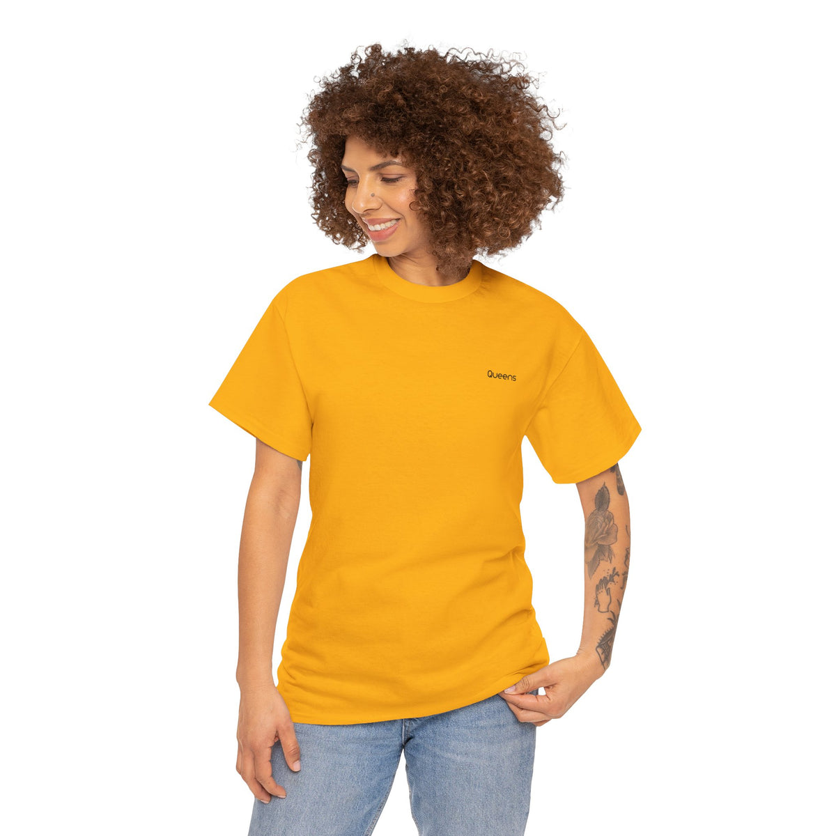 Woman modeling a yellow Queens T-shirt with short sleeves and blue jeans.