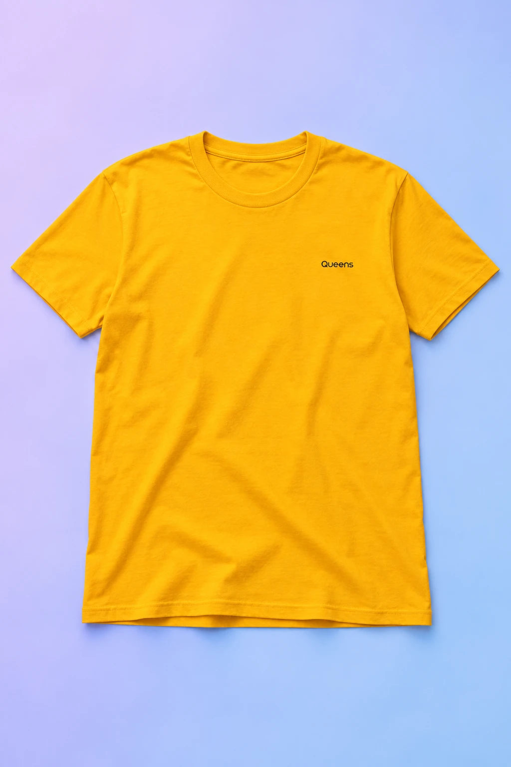 Yellow Queens T-shirt laid flat on a soft lavender and blue gradient background.