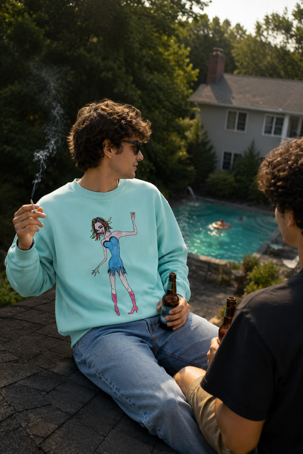 Back view of the Rainbow Nights Unisex Sweatshirt in a summer rooftop lifestyle scene overlooking a suburban swimming pool.