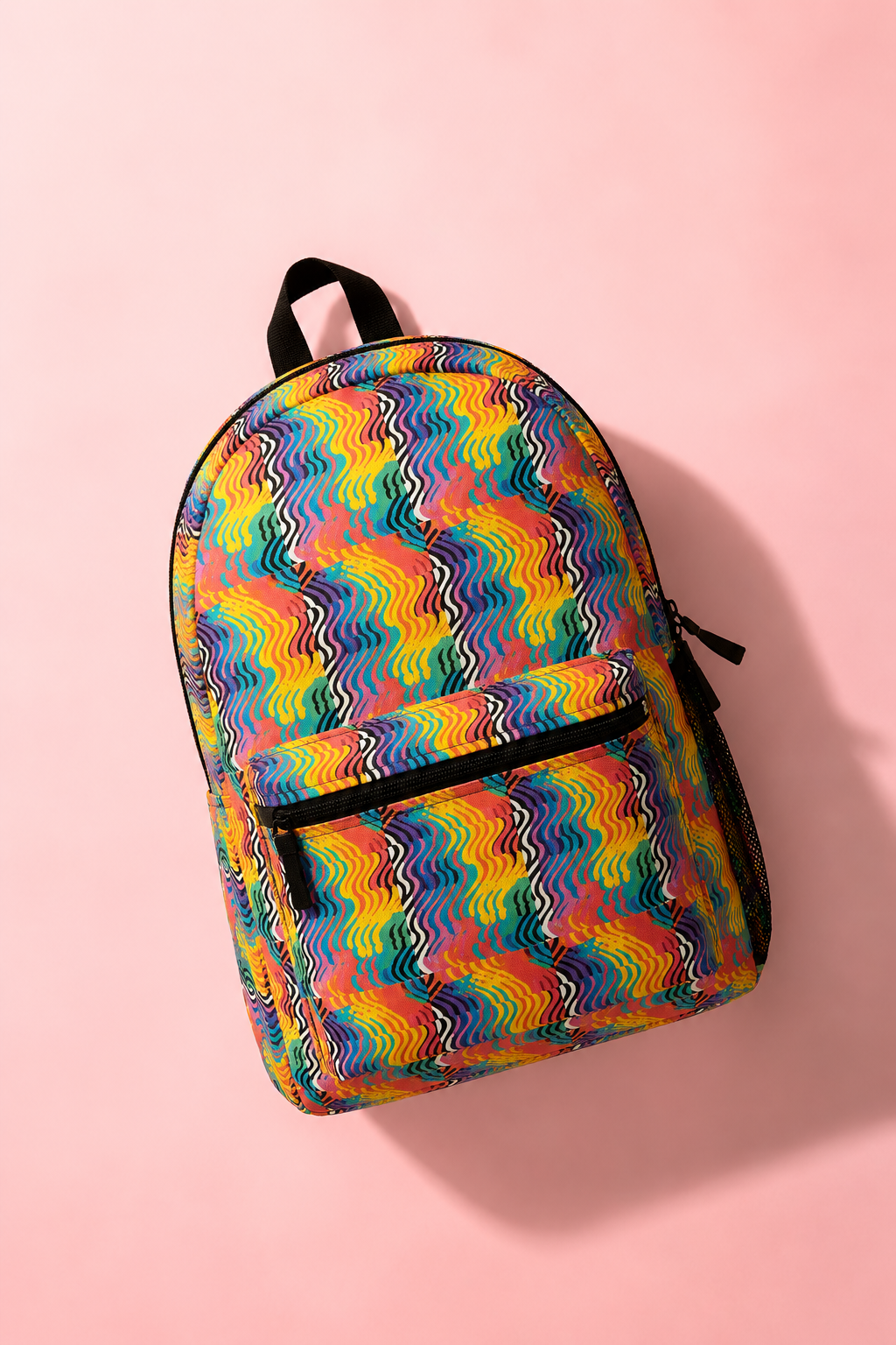 Rainbow Wave backpack flat lay front view on pastel pink background